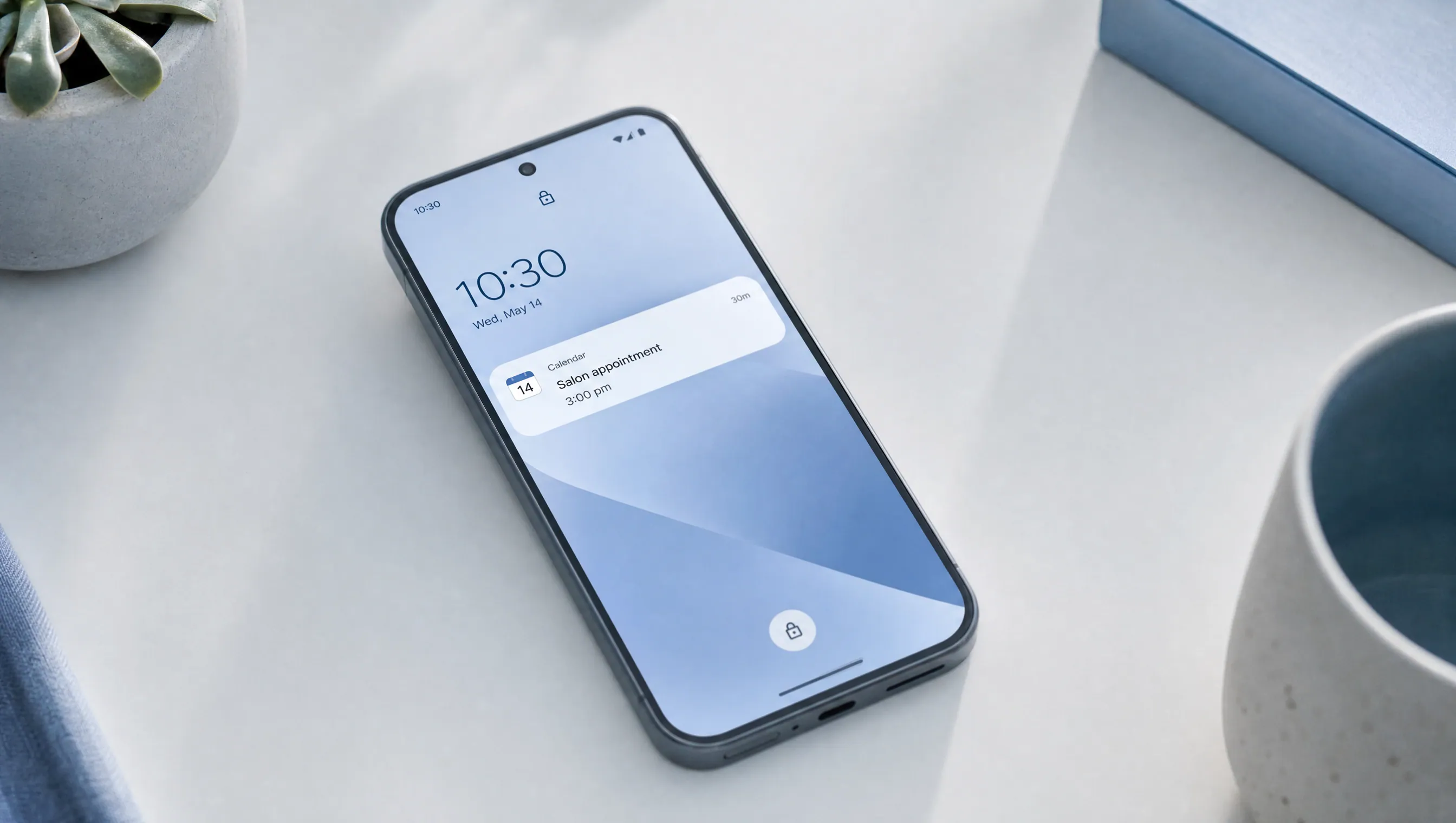 A phone resting on a desk showing a calendar reminder on the lock screen